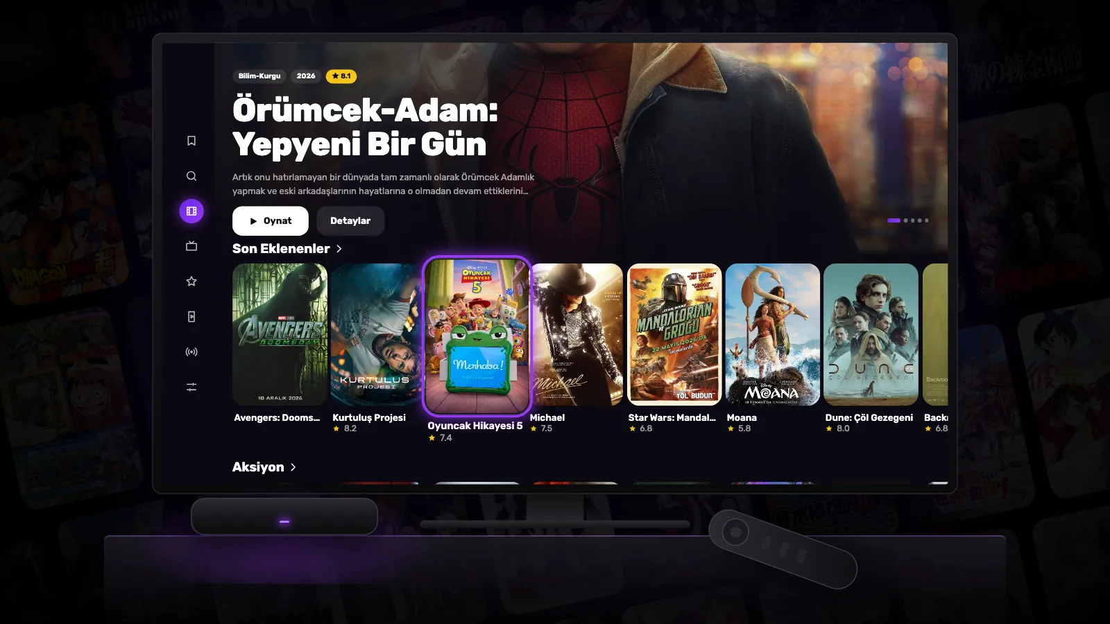 Reeltu açık bir televizyon; önünde küçük bir Android TV box ve yanında kumandası.